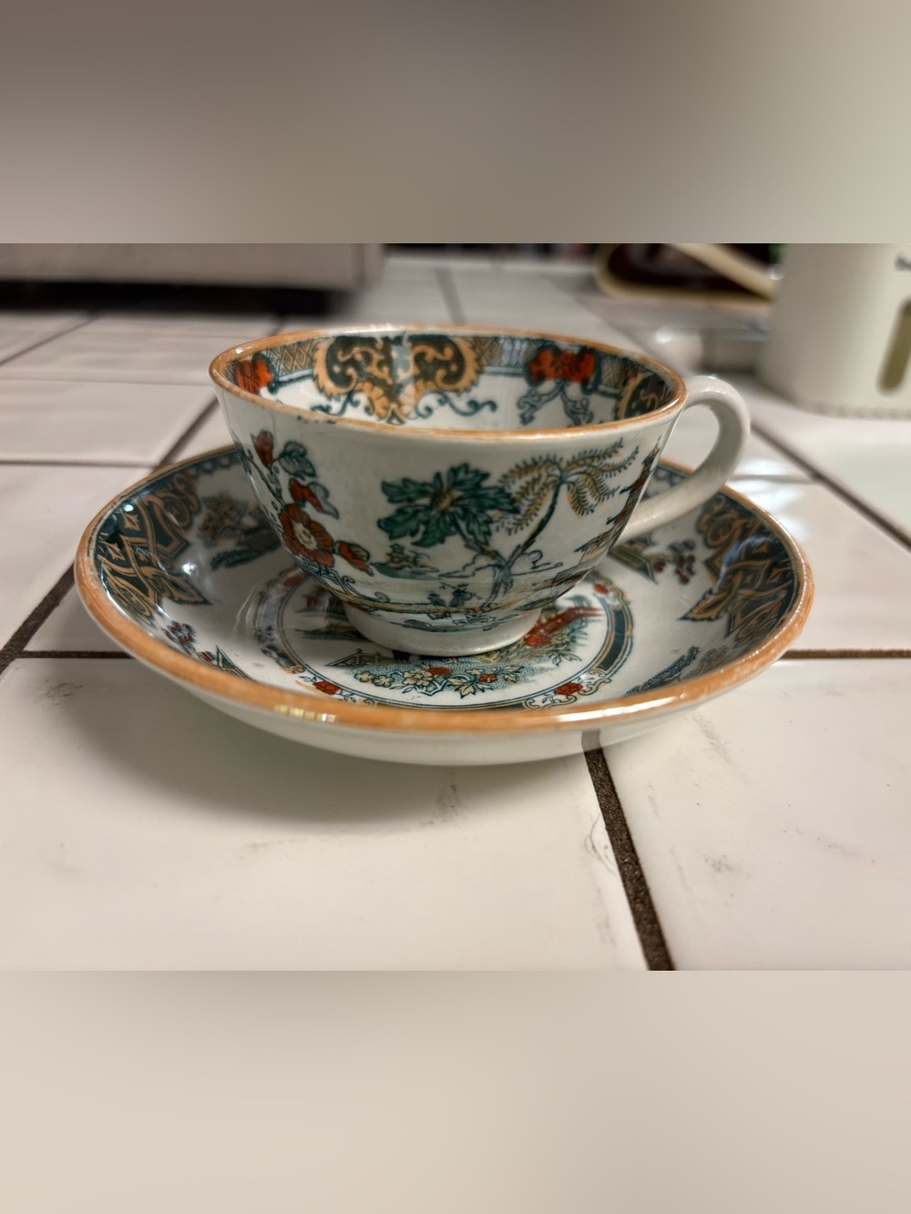 Vintage Floral Porcelain Teacup and Saucer - White with Green & Orange Accents